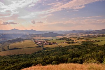 The beautiful sunset above the peaks of Central Bohemian Highlands from hill Radobyl, Czech republic