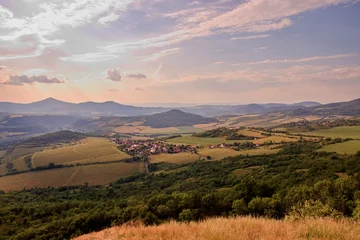 Tuinposter The beautiful sunset above the peaks of Central Bohemian Highlands from hill Radobyl, Czech republic © Czech Made Photo