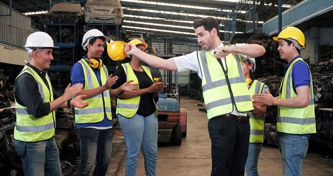 Multiracial Warehouse Workers Dancing To Relax After Working Hard At Old Motor Automotive Parts Warehouse. Spending Time Together To Celebrate The Success Of Jobs. Unity And Teamwork Concept