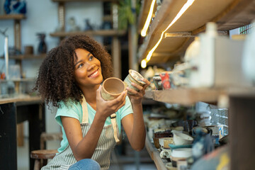 Capturing the essence of pure joy, a girl's cheerful smile illuminates the ceramic studio, reflecting her enthusiasm for learning and working with clay, making every moment a delightful adventure.