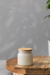 Fototapeta na wymiar White interior candle in a glass jar. Home decor, comfort. Handmade candle