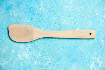 top view wooden spoon on blue background
