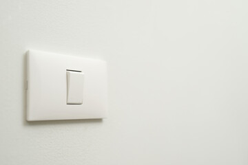 Electronic lighting switch with white wall background. home electrical power.
