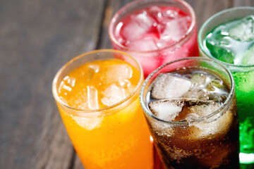 Soft drinks and fruit juice mixed with soda high in sugar have a negative effect on physical health - obrazy, fototapety, plakaty
