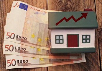 House with euro banknotes and arrow going up , concept of housing and economy