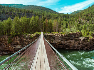 Kootenai falls hiking bridge into wilderness in Montana 