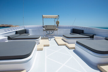 Fototapeta na wymiar Sun beds on sundeck of a luxury motor yacht