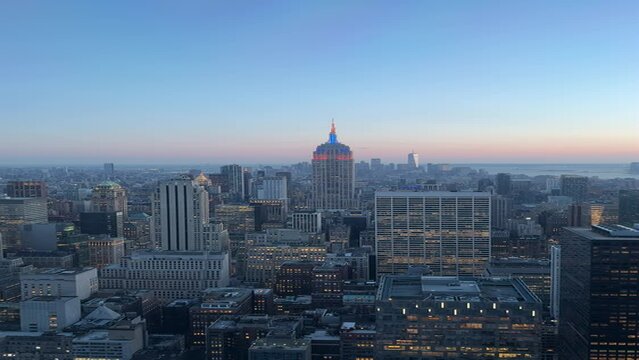 View from the top of Rockefeller Center in New York City at dusk, looking south toward the Empire State Building.