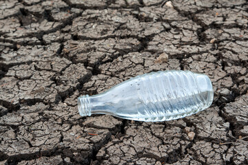 A water bottle lonely on a parched ground. Climate change brings water scarcity to Europe. Every...