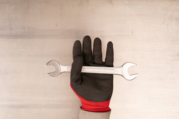  Cropped image of hand holding wrench on white background