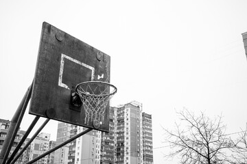 An old basketball hoop in a poor neighborhood. Streetball basket. Basketball hoop in the ghetto