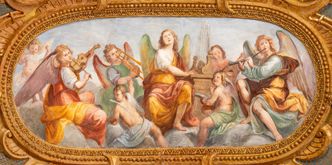 GENOVA, ITALY - MARCH 5, 2023: The fresco of angels choir with the music instrumenst in the church...