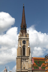 Fototapeta na wymiar Facade details and bell tower of the cathedral in Novi Sad. The Name of Mary Church.