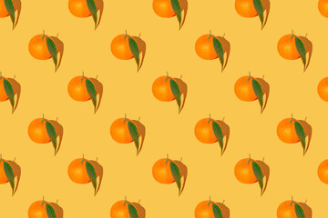 Creative pattern made of fresh orange mandarin with green leaf on bright background. Summer refreshment and vitamin concept. Minimal style