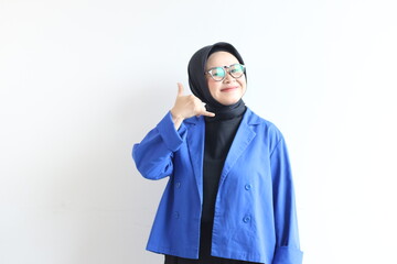 Beautiful young Asian Muslim woman, wearing glasses and blue blazer with mobile phone gestures and smiling facial expressions