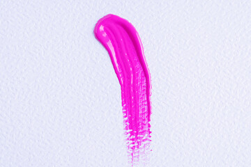 Pink paint swatch on white paper background. Bright pink swatch of lip gloss, cosmetic product...