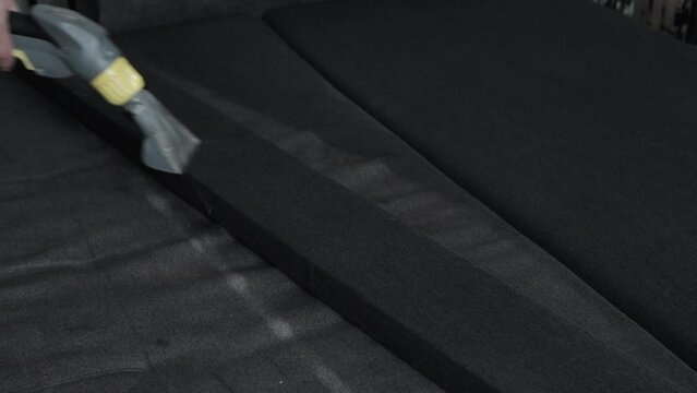 Professional dry cleaning of the sofa with a special chemical solution and a washing vacuum cleaner. Copy space for text