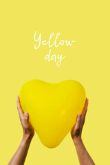 man with a yellow balloon and text yellow day