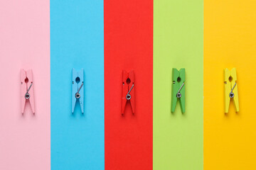 Lot of colorful clothespins on colored background