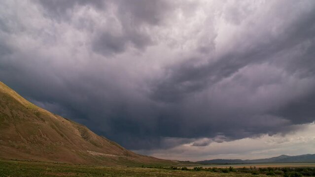 Timelapse of storm clouds moving overhead along West Mountain in Utah during Spring storm.