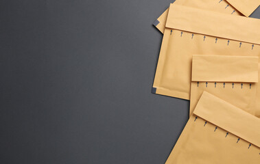Parcel envelopes on dark background. Top view. Copy space