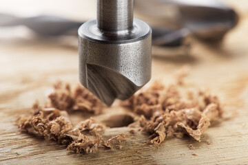 Countersink drill bit with steel triangle ruler make sink in hole for screw in wooden oak plank
