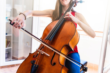 Concert Preparation: Young Cellist Devotedly Rehearsing at Home