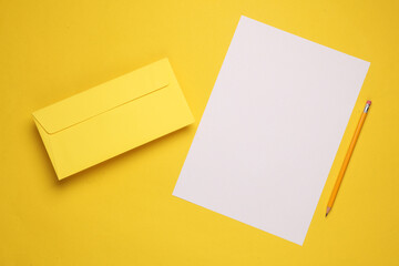 Yellow envelope and sheet of paper with a pencil on a yellow background