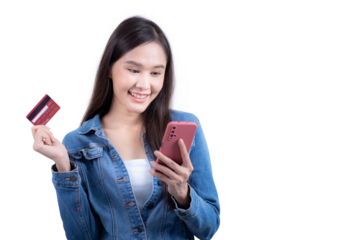 Standing sweet woman in denim shirt holding smartphone and credit card in hand. Isolated on white background