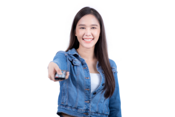 Standing sweet woman in denim shirt pressing remote control in hand. Isolated on white background