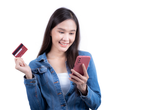 Standing sweet woman in denim shirt holding smartphone and credit card in hand. Isolated on white background