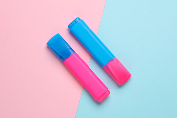 Blue and pink markers on pink blue background