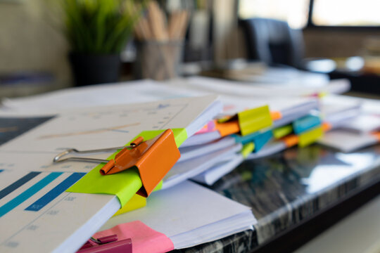 A huge stacked documents is an annual earnings summary document prepared for business people to use in attending meetings and this stacked paper is also an important document.