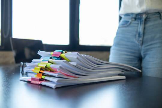A huge stacked documents is an annual earnings summary document prepared for business people to use in attending meetings and this stacked paper is also an important document.