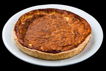 Fresh baked cheese pie on a white plate.