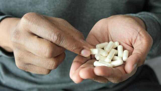 men hand pick herbal medicine capsule 