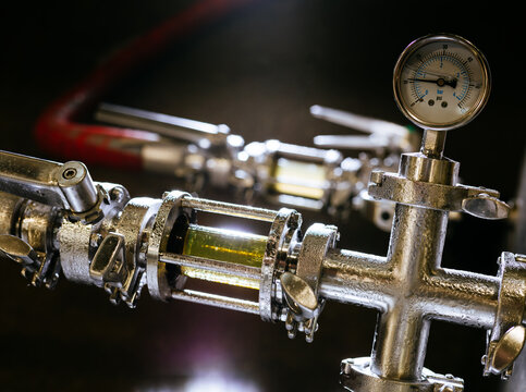 Stainless steel pipes carry unfiltered (far) and filtered (close) beer at a brewery