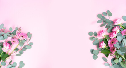 wedding or mothers day background, bouquet of roses and herberas with fresh eucaliptus leaves over plain pink background