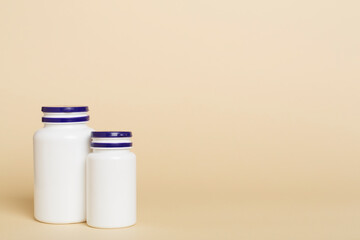 Plastic bottles for vitamins on color background