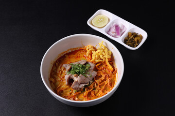 Khao Soi Thai Curry soup isolated in black background