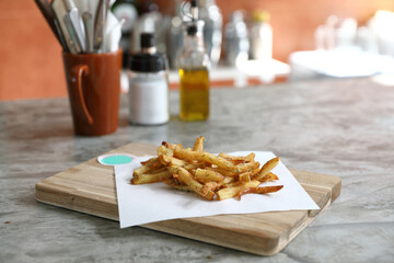 Homemade French fries on rustic wooden table