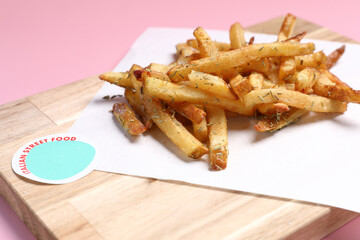 Homemade French fries on rustic wooden table