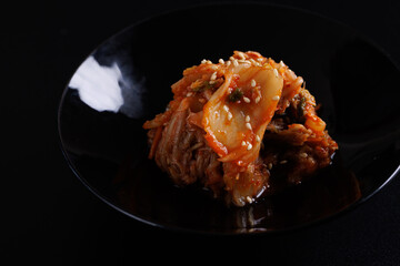 Korea food cabbage kimchi in black isolated in black background