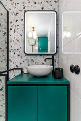 Bathroom with turquoise furniture, black faucets and shower
