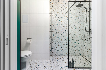Bathroom with turquoise furniture, black faucets and shower