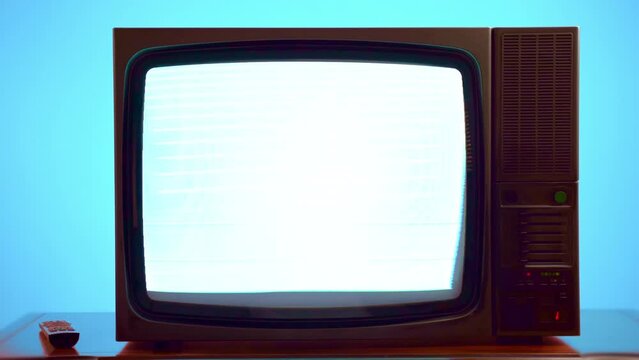 Interrupted broadcasting and news transmission on broken vintage TV against blue background, retro television with blinking stripes and screen distortion because of bad satellite signal, flickers on