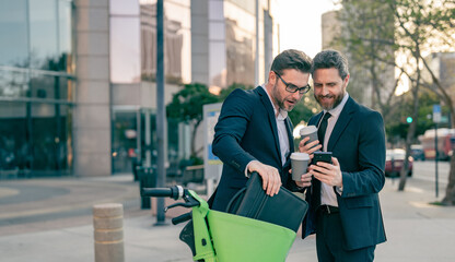 businessmen discussing business with phone in the street, copy space banner