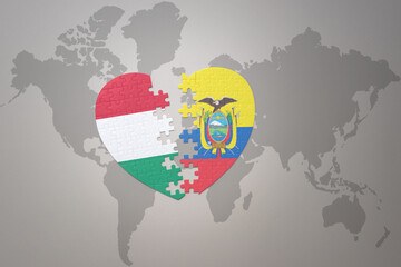 puzzle heart with the national flag of ecuador and hungary on a world map background.Concept. - obrazy, fototapety, plakaty