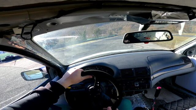 POV driver inside the sports car quickly steering wheel and doing dangerous extreme maneuvers in drifting, unsafe turns and drifting techniques of skilled driver, drifting competitions and feeling of