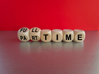 Full or part time. Turning cubes and changes the word 'full-time' to 'part-time' or vice versa. Beautiful grey table, red background. Business and full-time concept. Copy space.